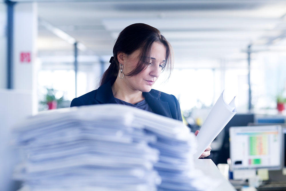 Cilex case illustration - young woman in law office working on paperwork